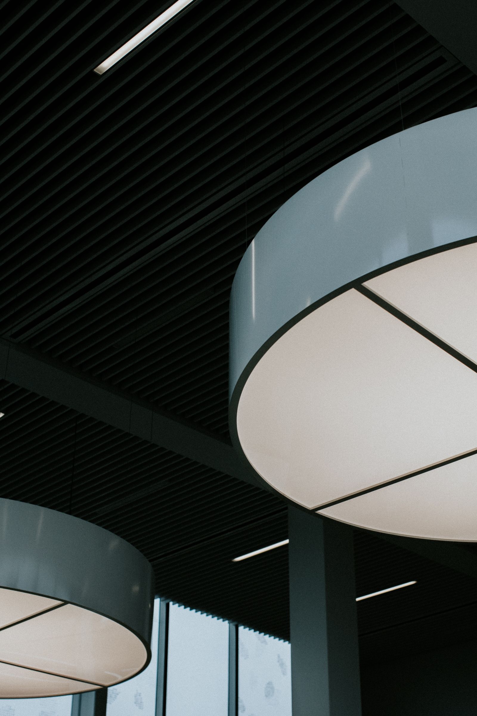 Sample image of large round ceiling lights in a modern commercial interior